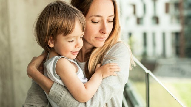 A single mom holding her son as she's celebrating Mother's Day with him.