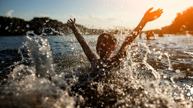 A person in the sea splashing, experiencing secondary drowning