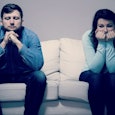 Man and woman sitting on the couch who have realized it was time to end their marriage