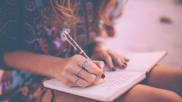 A mom sitting with a diary on her lap and writing