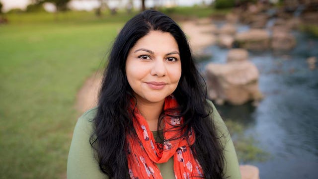 Sara Ahmed, a Muslim immigrant in America with long dark hair smiling, wearing an olive sweater and ...