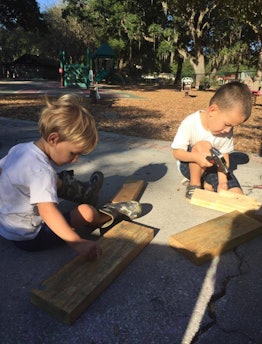 Boys playing with wood blocks and hammers 
