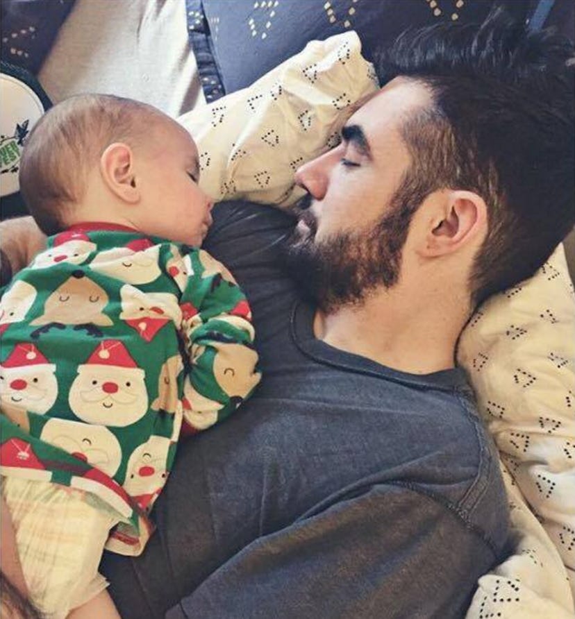 A baby sleeping on her dad's chest 