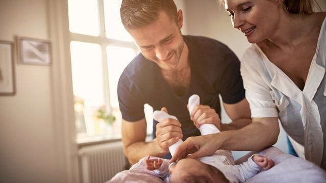 Husband and wife playing with their baby