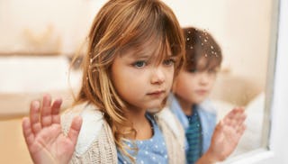 A girl and a boy from the blended families looking out the window