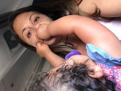 A woman and her toddler daughter playing during an airplane flight