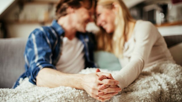 Happy husband and wife holding hands and smiling