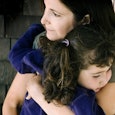 A mother hugging her daughter that has the autism/ADHD diagnosis
