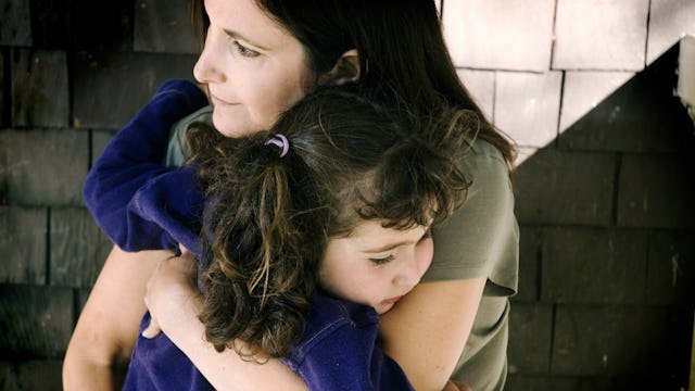 A mother hugging her daughter who has the autism/ADHD diagnosis