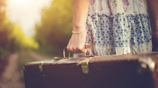 Woman Holding A Suitcase After The Divorce With A Pyschopath