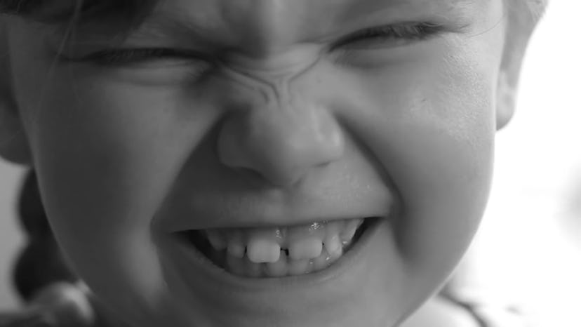 Black and white picture of an angry little girl 