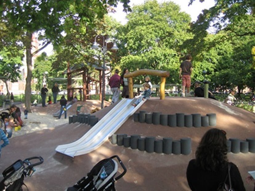 Parents watching their children play at the Alexander W. Kemp Playground in Cambridge, Massachusetts
