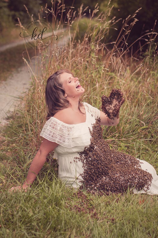 A pregnant woman laughing while 20,000 bees are swarming on her belly 