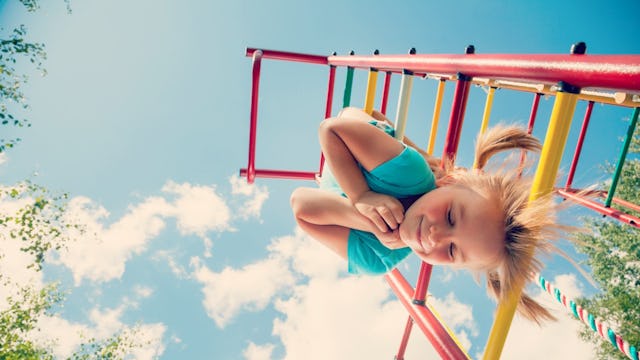 Girl Hanging Upside Down From Monkey Bars