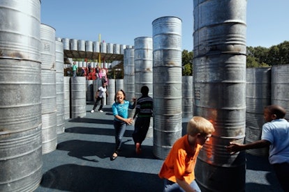 Children running through the Rural Studio Lions Park Playscape in Greensboro, Alabama