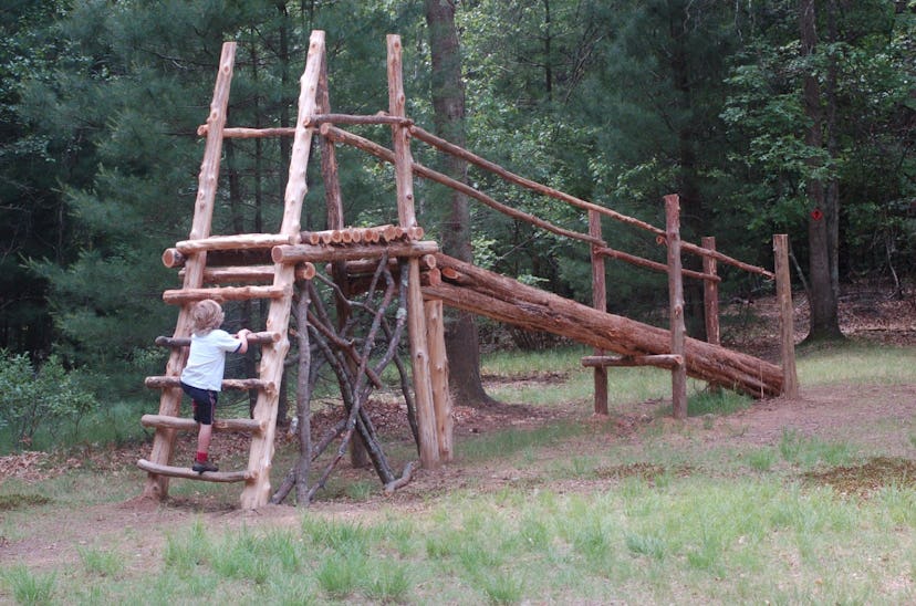 A child climbing the Natural Playground at Westport, Connecticut