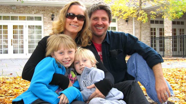 Family portrait with two kids and a husband of a woman who survived a pulmonary embolism with her fa...