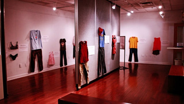An exhibition that contains different clothes hanging on a wall named 'What Were You Wearing?'' dedi...