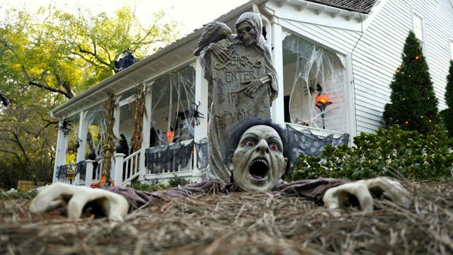 Scary Halloween decorations in front of a white house