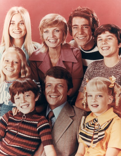 The whole Brady Bunch family posing for a photo 