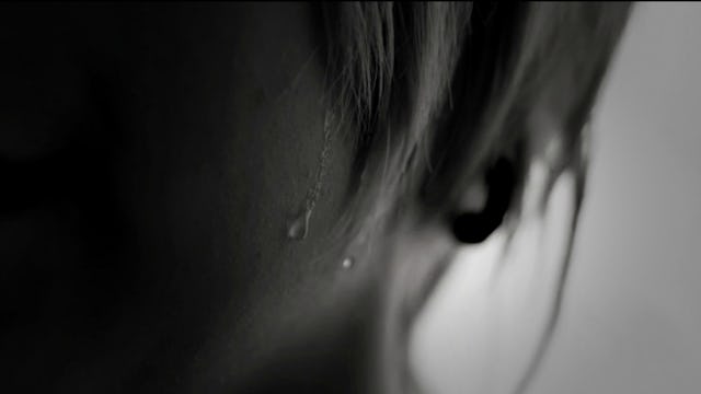 A young woman's face experiencing Hyperhidrosis that causes excessive sweating