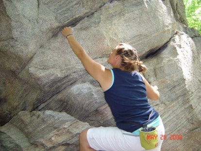 Woman climbing a rock