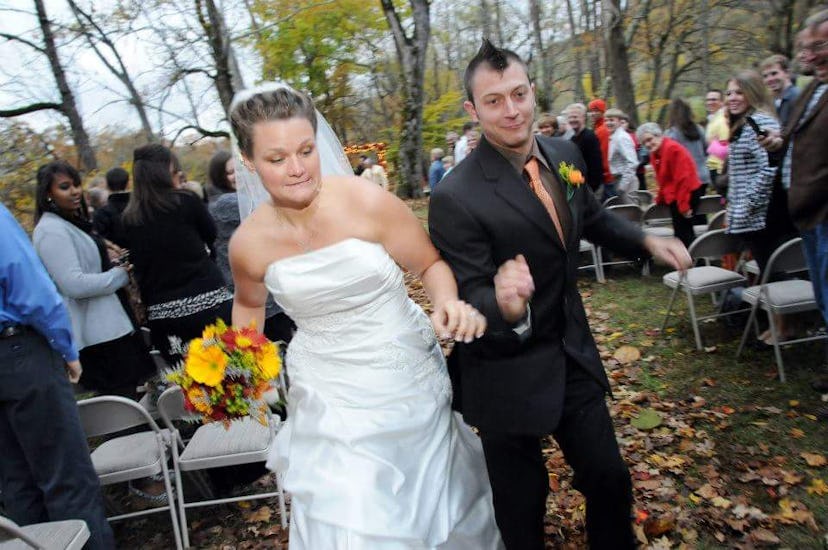 Couple running down the aisle on their wedding 