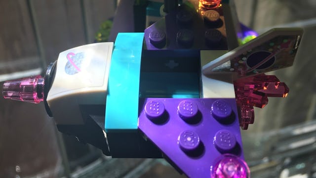 A colorful spaceship made out of Legos.