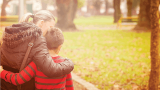 Mom and son walking in a park after leaving a narcissistic ex-husband.