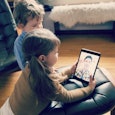 Two Little Kids On A Video Call With Their Dad