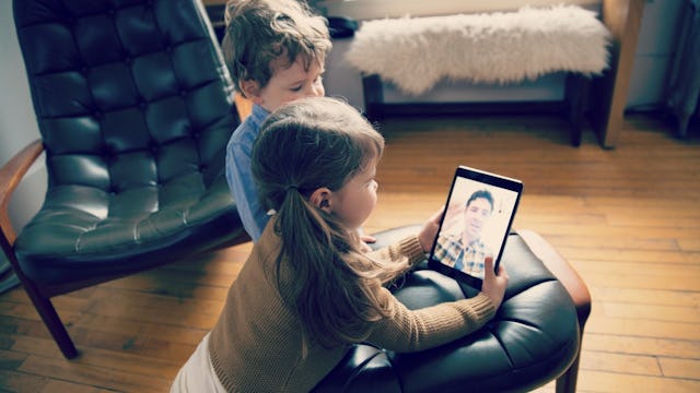 Two Little Kids On A Video Call With Their Dad
