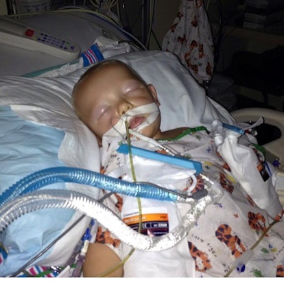A 20-month-old son who was diagnosed with neuroblastoma is laying on the hospital bed