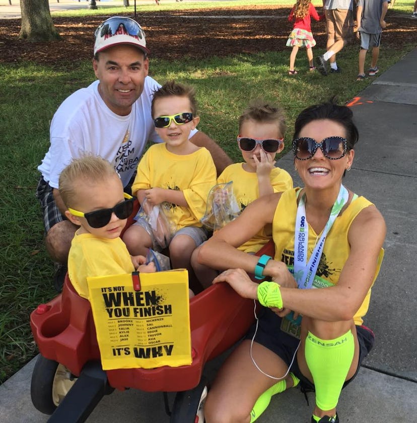 A child with neuroblastoma posing and smiling with his family in a park