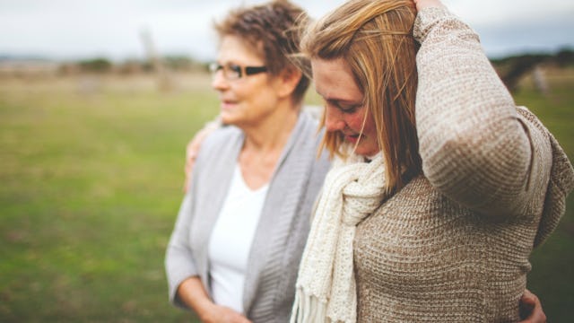 A woman and her ex-mother-in-law hugging while walking