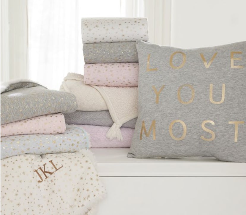 A grey "Love You Most" decorative pillow