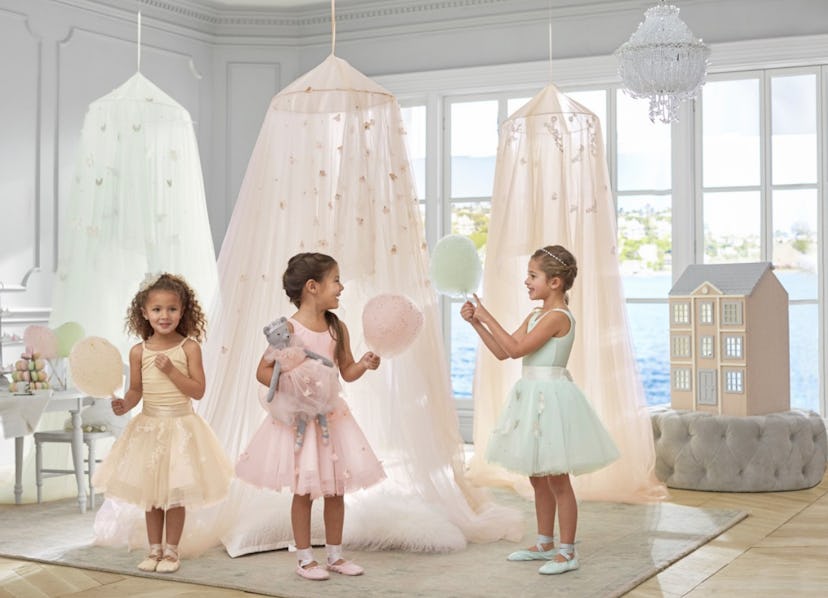 Light, blue, white, and pink Monique Lhuillier butterfly chandeliers and three girls in matching dre...