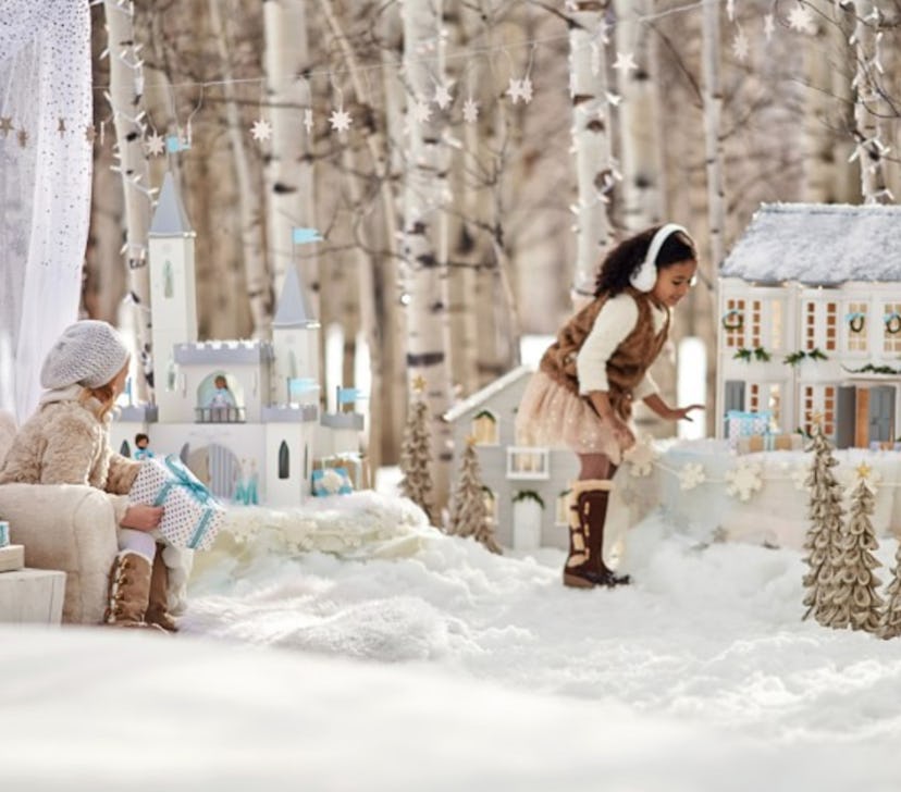 A Greenwhich dollhouse in snow and two girls playing
