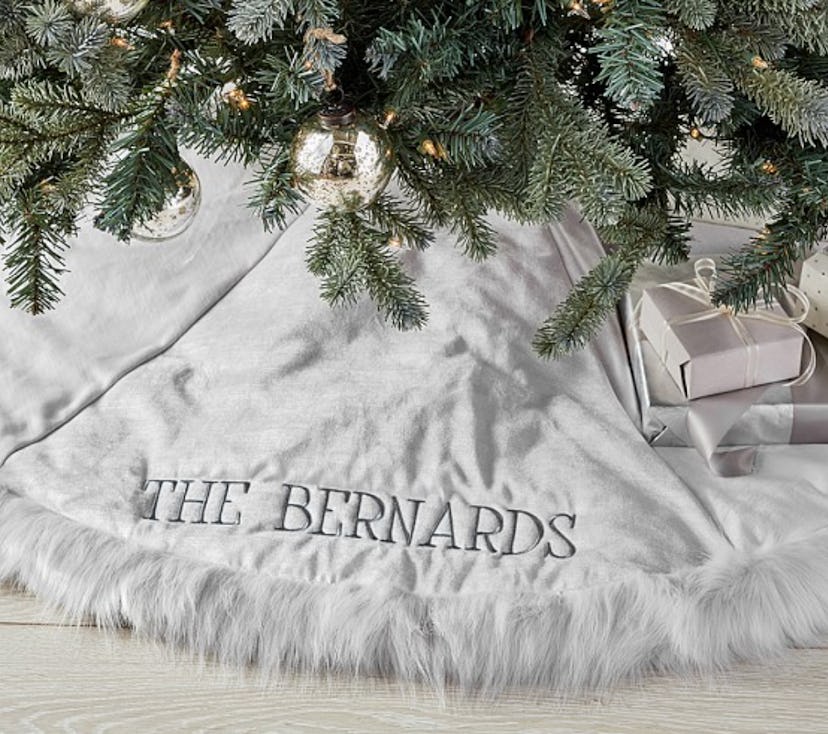 A white Monique Lhullier Tree Skirt with a "The Bernards" text
