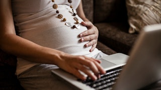 Pregnant woman working on her laptop 