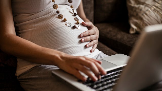 Pregnant woman working on her laptop