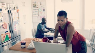 A woman with a laptop on the kitchen island is not sorry because she unfriended people, and a man in...