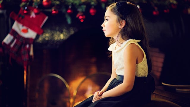 A girl with autism sitting sad and alone during Christmas after learning that Santa doesn't exist