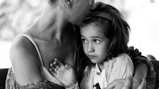 A divorced woman hugging her little girl in black and white