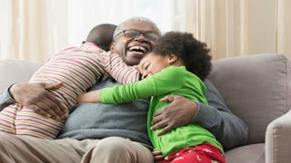 Grandpa hugging his grandchildren 