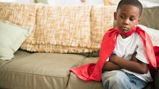 A 7-year-old kid sitting on the couch 