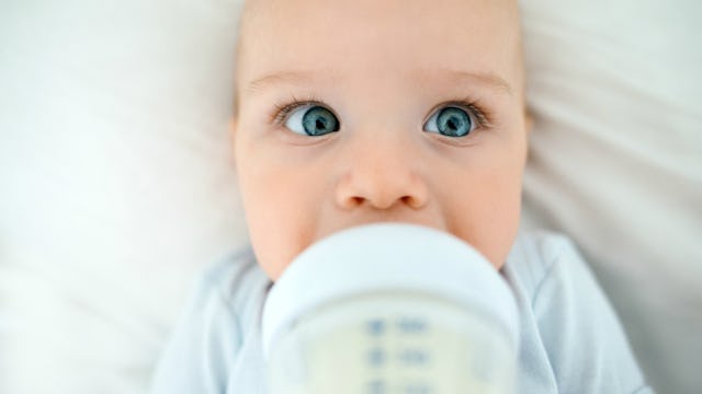 A little baby drinking milk from the bottle