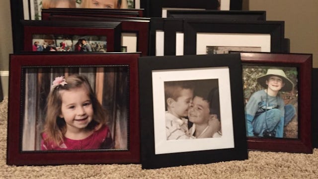 Photos of children at various stages of their lives displayed in frames.