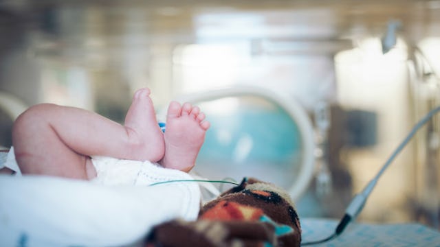 A baby lying in an incubator at the NICU