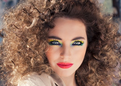 Curly-haired woman with colorful, heavy make-up