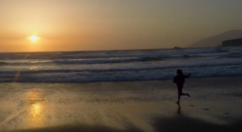 A scene from 'A Boy Called Po' movie showing Julian Feder as Po running on the beach in the sunset.